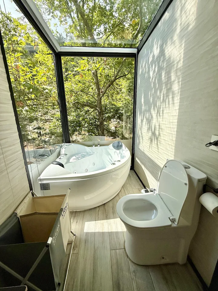 Corner jacuzzi with floor-to-ceiling glass windows