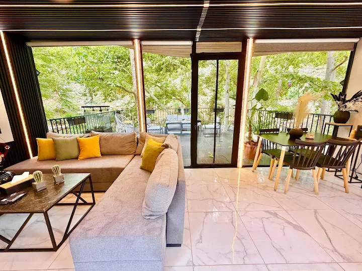 Spacious living area with L-shaped sofa and floor-to-ceiling windows